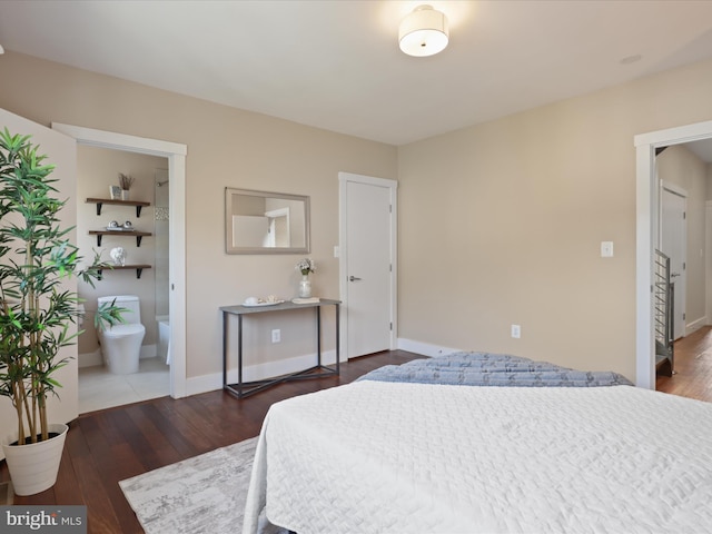 bedroom with dark hardwood / wood-style floors and connected bathroom