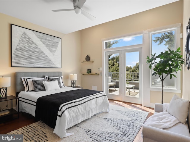 bedroom with access to exterior, french doors, hardwood / wood-style flooring, and ceiling fan