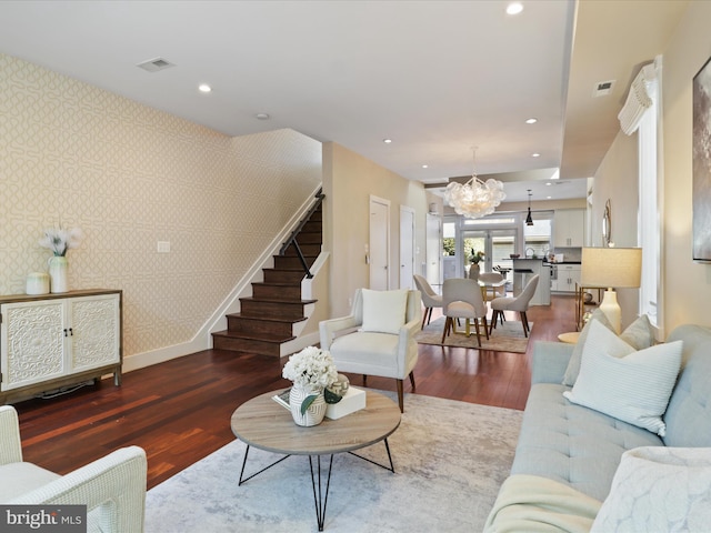 living room featuring hardwood / wood-style flooring and a notable chandelier