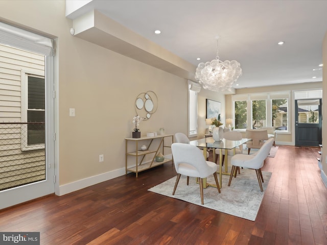 dining room featuring dark wood-type flooring and an inviting chandelier