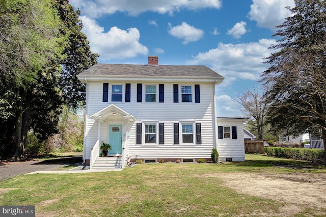 colonial-style house with a front yard