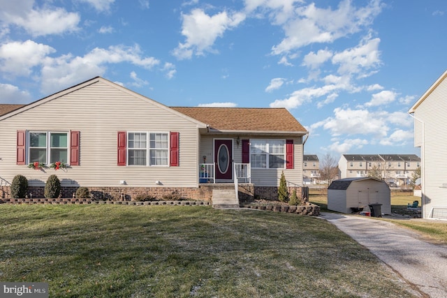 view of front of property featuring a front yard and a storage unit