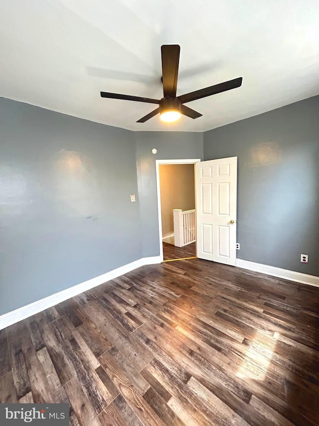 unfurnished bedroom with ceiling fan and dark hardwood / wood-style flooring