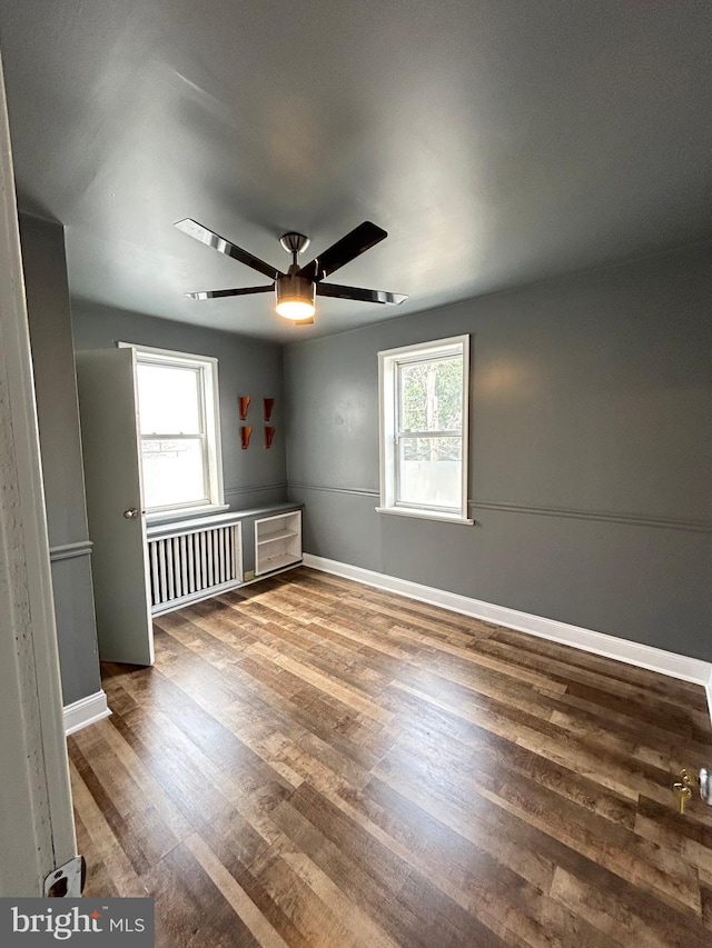 empty room with hardwood / wood-style flooring and ceiling fan