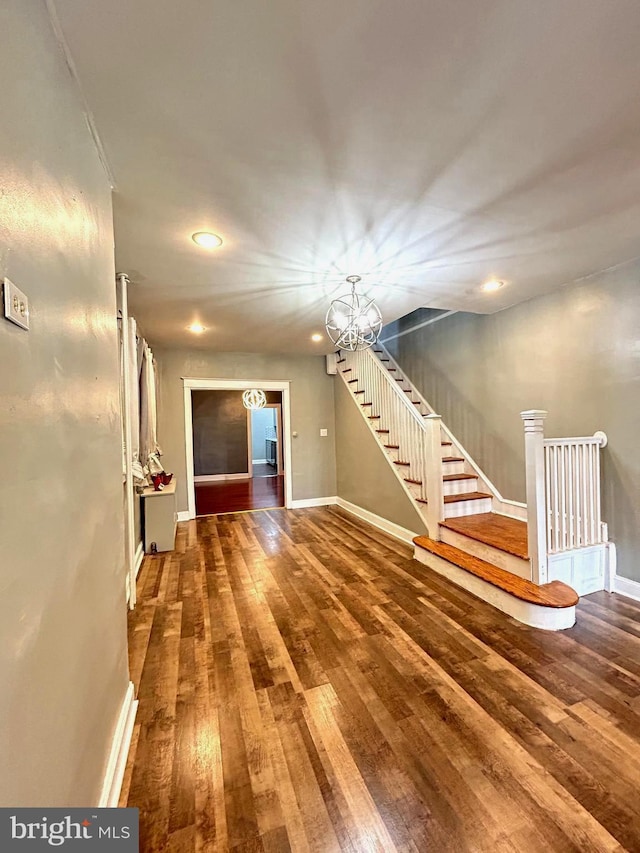 interior space featuring hardwood / wood-style flooring and a notable chandelier