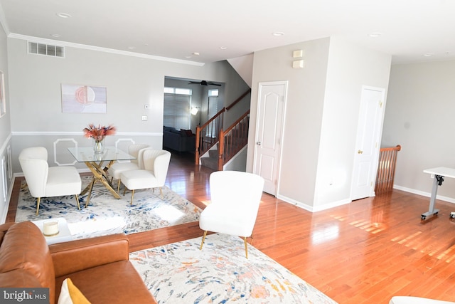 living room featuring light hardwood / wood-style floors and ornamental molding