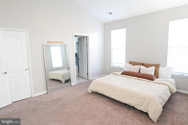 bedroom featuring carpet flooring and high vaulted ceiling