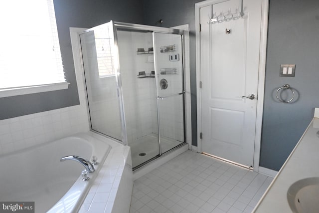 bathroom with tile patterned flooring, vanity, and separate shower and tub