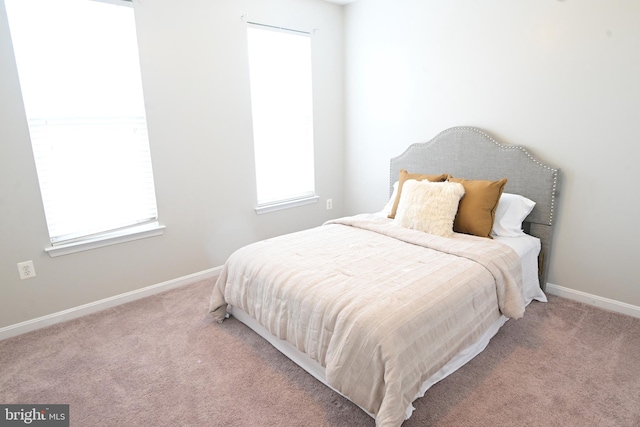 bedroom with light colored carpet