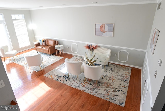 living room featuring hardwood / wood-style floors and ornamental molding