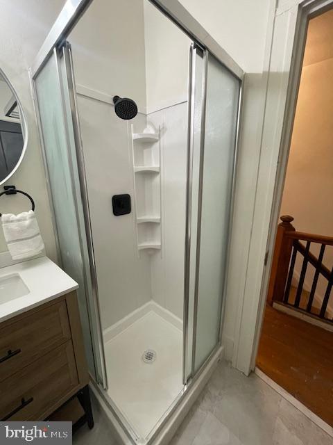 bathroom featuring vanity and a stall shower