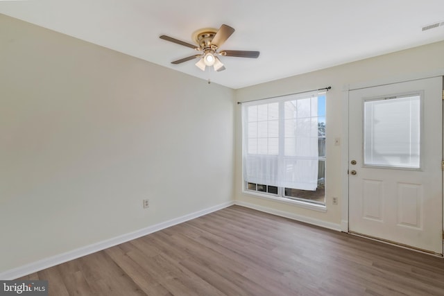 foyer entrance featuring wood-type flooring and ceiling fan