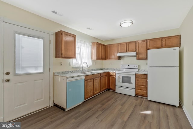 kitchen with white appliances, dark hardwood / wood-style floors, and sink