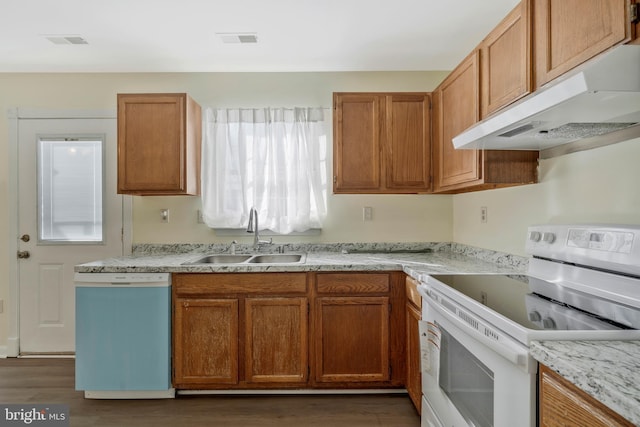 kitchen featuring dark hardwood / wood-style floors, white appliances, and sink