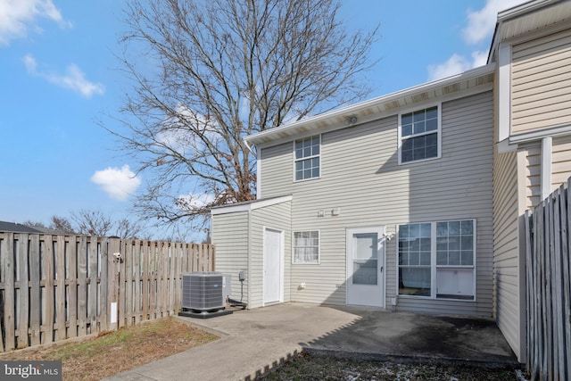 rear view of house featuring a patio and central air condition unit