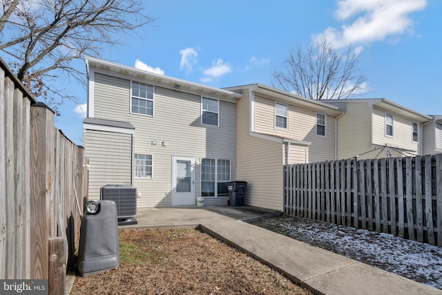 back of house featuring central air condition unit and a patio