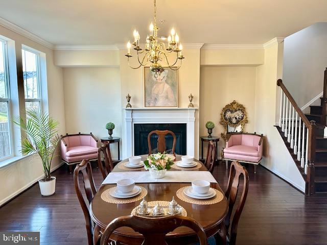 dining room with plenty of natural light, crown molding, and dark wood-type flooring