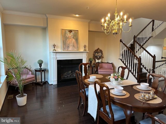 dining space featuring a chandelier, ornamental molding, and dark wood-type flooring