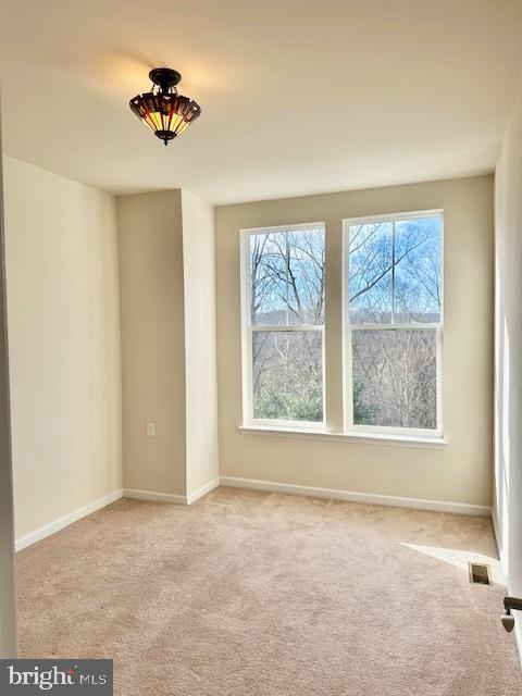 empty room featuring light colored carpet