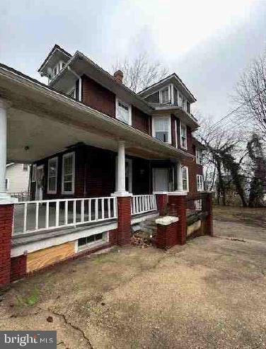 view of side of property with a porch