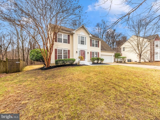 view of front of home with a front yard and a garage