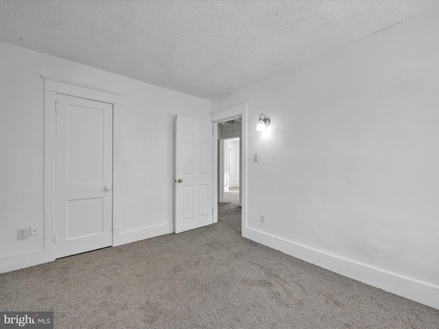 unfurnished bedroom with carpet flooring and a textured ceiling