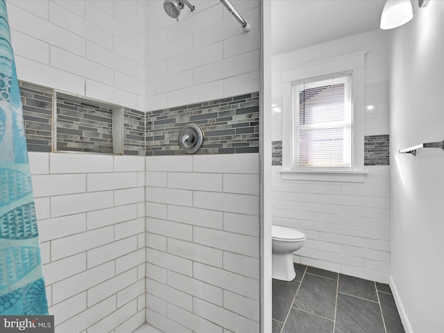 bathroom featuring a shower with shower curtain, tile patterned flooring, and toilet