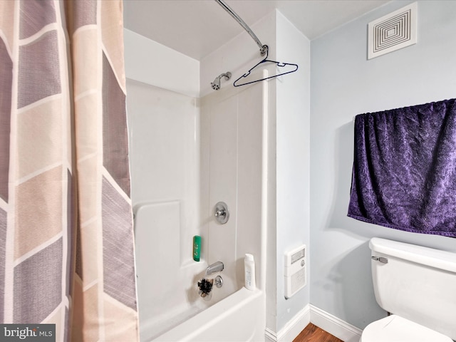 bathroom featuring toilet and shower / tub combo with curtain