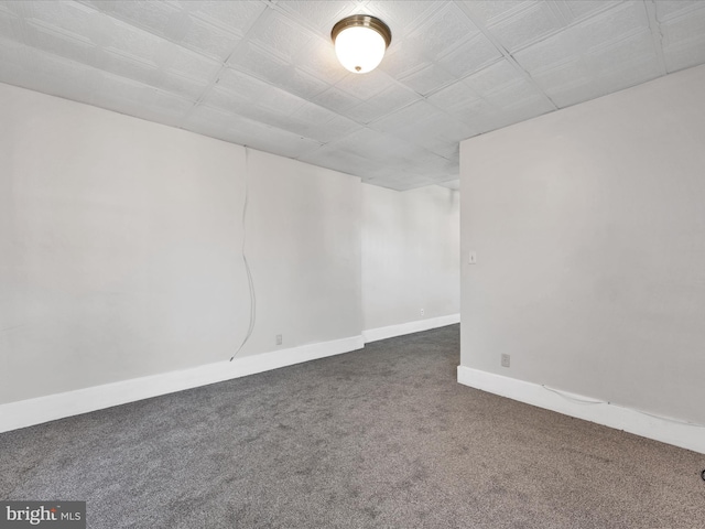 basement featuring dark colored carpet