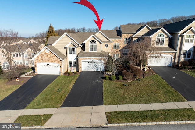 front facade with a garage and a front yard