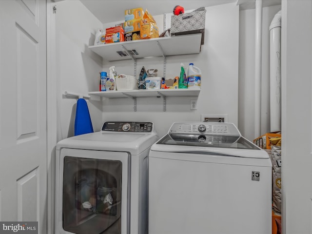 clothes washing area featuring washer and clothes dryer