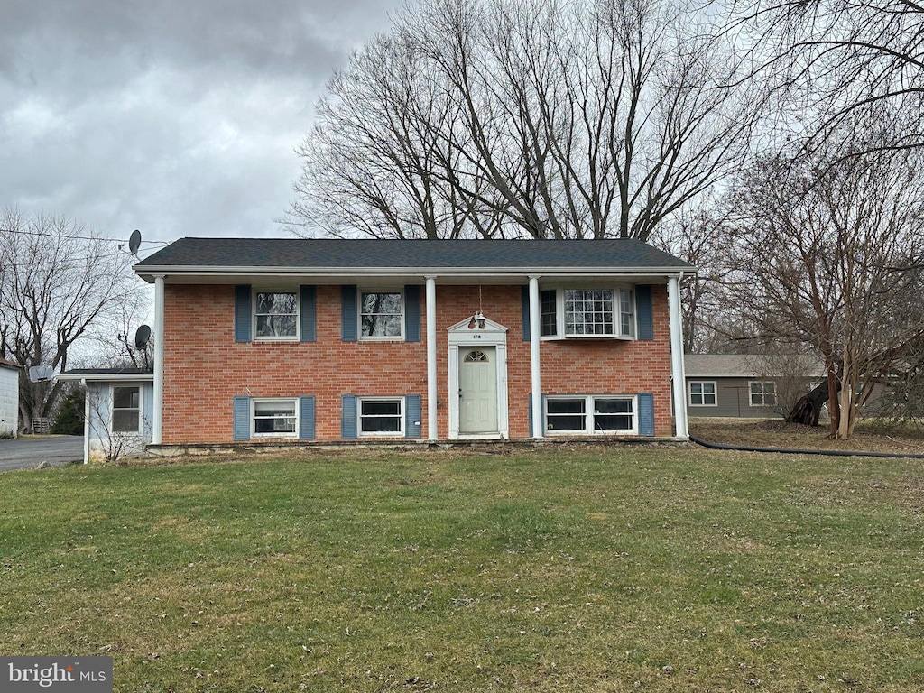 raised ranch featuring a front yard