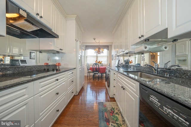 kitchen featuring under cabinet range hood, a sink, white cabinetry, black appliances, and washer / clothes dryer