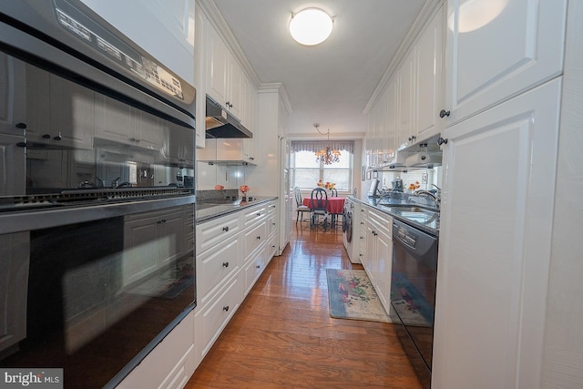 kitchen with black appliances, a sink, white cabinetry, and under cabinet range hood