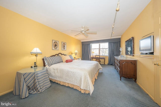 bedroom featuring rail lighting, carpet, baseboards, and a ceiling fan