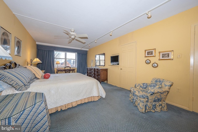 carpeted bedroom featuring a ceiling fan and rail lighting