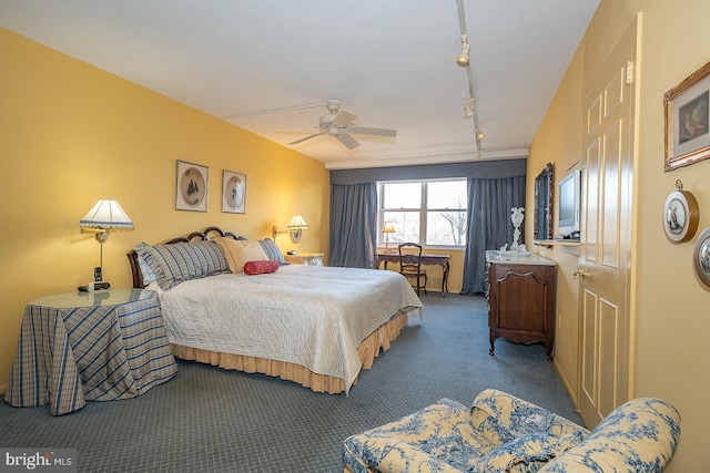 bedroom with a ceiling fan, carpet flooring, and track lighting