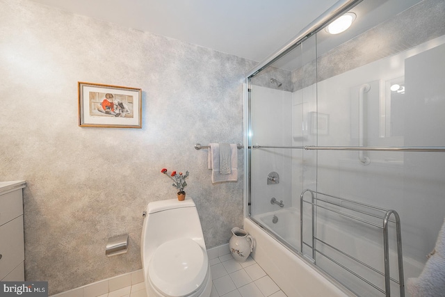 full bath with toilet, enclosed tub / shower combo, vanity, baseboards, and tile patterned floors