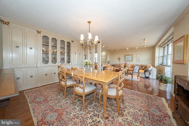 dining room featuring wood finished floors and an inviting chandelier