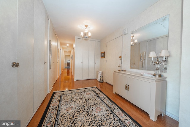 bathroom with an inviting chandelier and wood finished floors