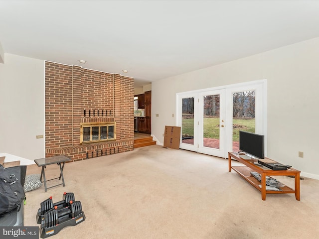 carpeted living room featuring french doors and a brick fireplace