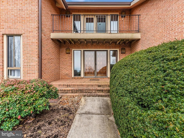 entrance to property featuring french doors and a balcony