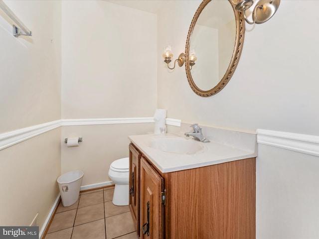 bathroom featuring tile patterned floors, vanity, and toilet