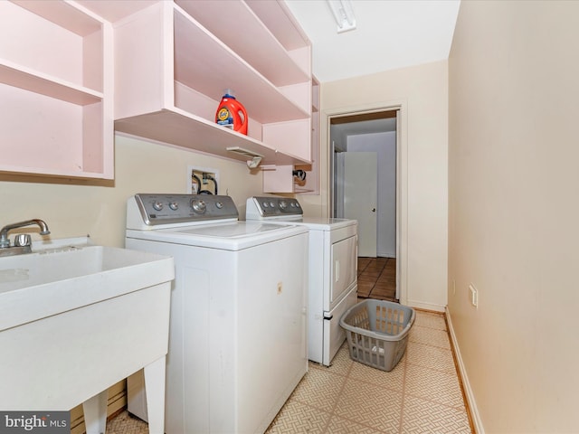 washroom with sink and washer and dryer