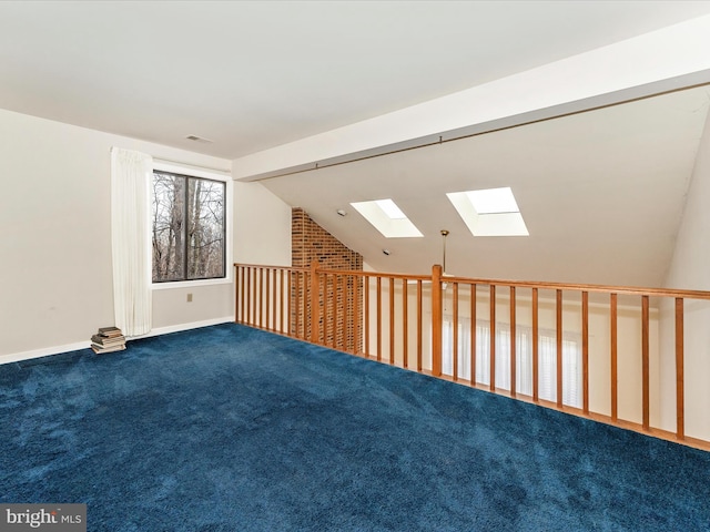 additional living space featuring carpet floors and lofted ceiling with skylight