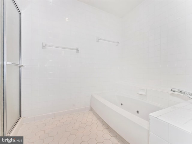 bathroom featuring tile patterned floors, separate shower and tub, and tile walls