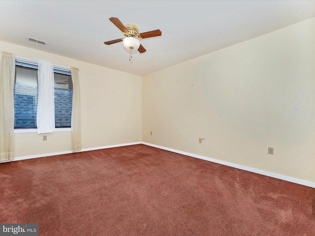 carpeted spare room featuring ceiling fan