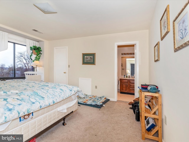 carpeted bedroom with ensuite bathroom