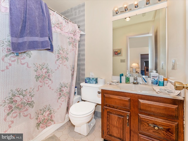 bathroom with tile patterned flooring, vanity, a shower with shower curtain, and toilet