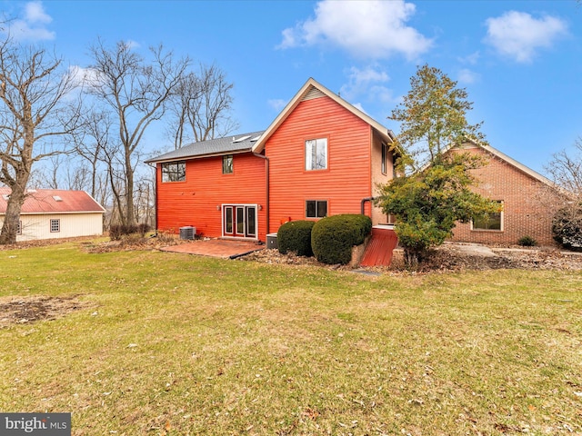 rear view of house with central AC, a yard, and a patio